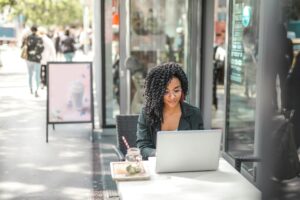 Girl using laptop in cafe