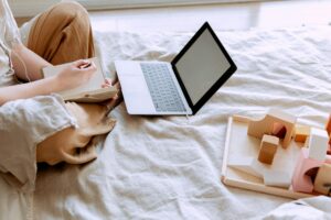 Girl working on laptop in her bedroom