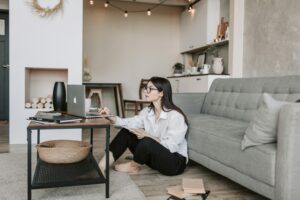 girl working on laptop with some books by her side