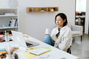 Girl working on her laptop and having a coffee